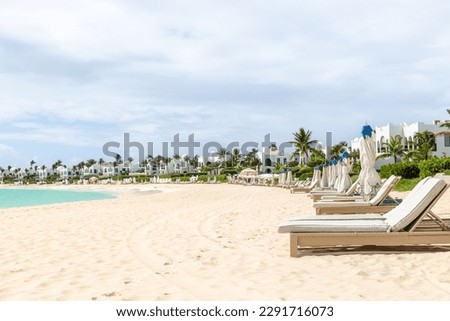 A row of chairs on an empty beach in Anguilla