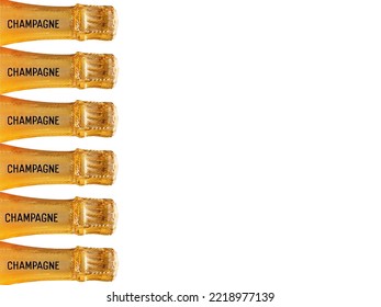 Row of champagne bottles covered in gold foil stamped with the word champagne on the neck against a plain pink background. No people. Copy space. - Shutterstock ID 2218977139