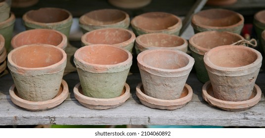 A Row Of Clay Pots On An Old Dusty Shelf