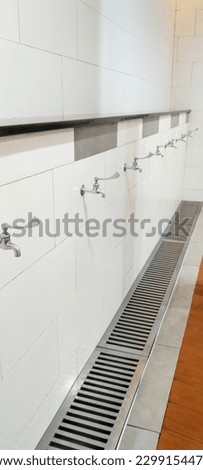 a row of clean water faucets to purify oneself.