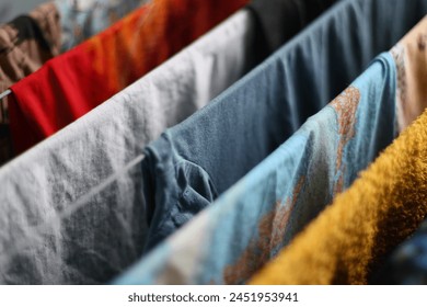 Row of clothes on a rack, versatile image for fashion or laundry concepts.