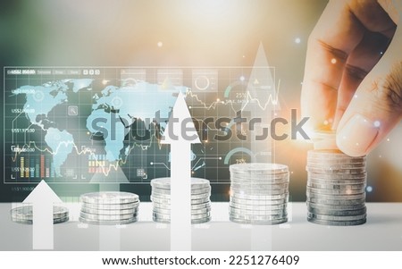 Row of coins with plants growing on them and a hand holding the coin for usage in financial such as bank accounts, business plans, and investments in stocks, bonds, dividends, and interests.
