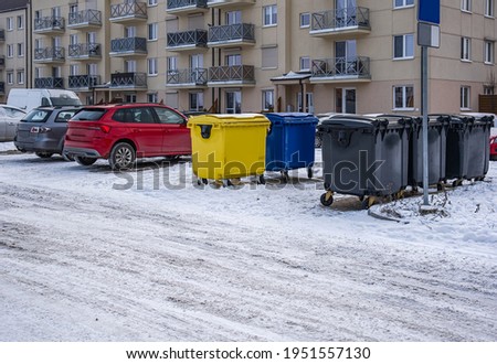 A row of colorful dustbins for waste segregation    .  streets of the city in Winter