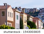 Row of colorful houses in the Marina District residential neighborhood; Pacific Heights residential district visible in the background; San Francisco, California