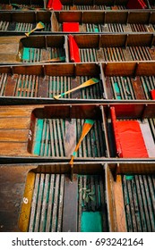 Row Of Colorful Punting Boats And Paddles Lined Up In Oxford