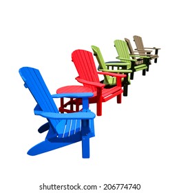 Row Of Colorful Recycled Plastic Resin Color Adirondack Chairs And Tables Made Of HDPE Recycling Lumber For Outdoor Patio Furniture Decor Isolated On White 