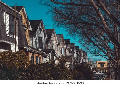 Row of colorful residential houses in Queens, NY on clear, sunny day - Shutterstock ID 1276001533