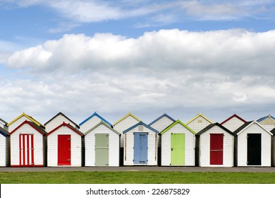 Row Of Colorful Wooden Beach Huts, Typical At English Seaside.