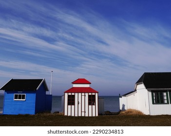 Row of colourful beach huts against blue sky on Danish island of Aeroe. High quality photo