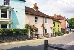 A Row Of Colourful Teeraced Cottages. Brightly Painted Small Cottage Homes In English Village.