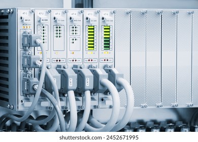 A row of computer cables with a clock on the left side.
