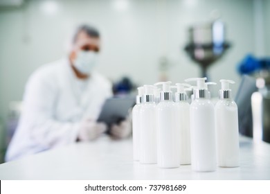 Row of cosmetics in front of a scientist in the fabric.