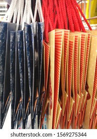 Row Of Craft Bags For Packing Gifts For The Holidays With Selective Focus. Eco-friendly Gift Wrapping. Preparation For The Holiday. Recycling Package. Paper Bags In Store 