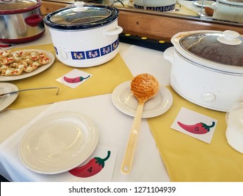 Row Of Crock Pots On Table For Chili Cook Off Contest