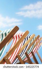 Row Of Deck Chairs On Beach