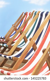 Row Of Deck Chairs On Beach