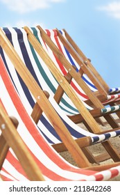 Row Of Deck Chairs On Beach