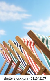 Row Of Deck Chairs On Beach