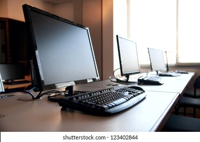 Row Of Desktop PCs Workplaces In The Classroom