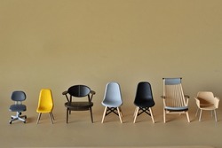 Row With Different Chairs In Modern Style Isolated On Light Brown Background.
