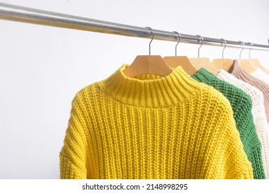 Row of different color sweater on hanger
