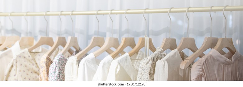 Row of different female clothes hanging on rack in hipster fashion show room in shopping mall. Trendy women wear - Powered by Shutterstock