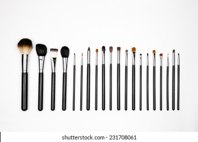 A row of different size makeup brushes