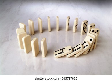 Row Of Dominoes In A Circle Shape On A Neutral Background