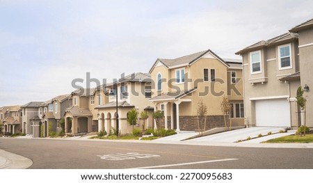 Row of double story suburban homes. Photo taken on a partly cloudy day