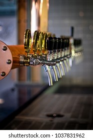 Row Of Draft Beer Tab On The Top Of Counter Bar In Closeup View, Time Of Celebration, Selective Focus.