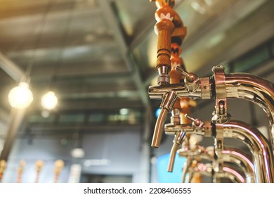 Row Of Draft Beer Taps At A Bar. Beer Taps In A Row In Perspective. Close Up Of Beer Tap. Selective Focus.