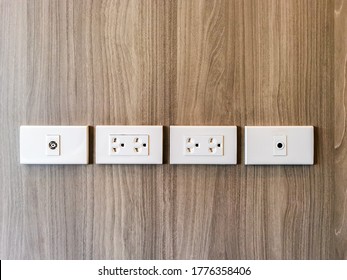 Row Of Electric Outlet Set In Bedroom Wall, TV Outlet , Cable Outlet And Electronic Plug With Asia Style On Wood Panel Wall Covering, Cable Television. Electricity Concept.