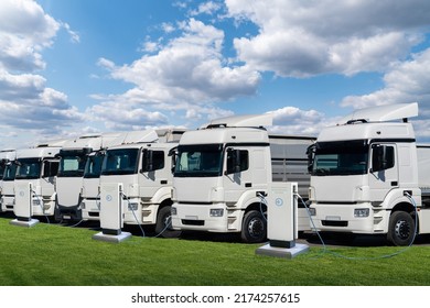 Row Of Electric Semi Trucks At Charging Stations For Electric Vehicles