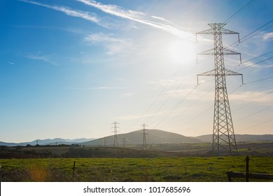 row of electricity pylons in Sardinia - Powered by Shutterstock