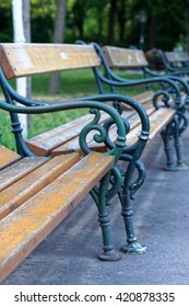 Row Of Empty Benches In Park