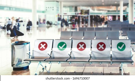a row of empty chairs with an indication of where it is possible to sit to maintain the social safety distance during the period of the COVID-19 coronavirus pandemic. Social distancing - Shutterstock ID 1696710007