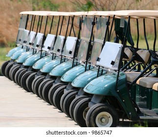 A Row Of Empty Golf Carts At A Course