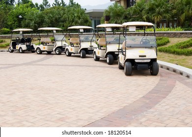 A Row Of Empty Golf Carts Waiting For Golfers At A Country Club