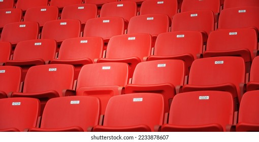 Row of empty red seats at stadium - Powered by Shutterstock