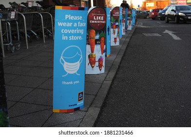 Row Of Floor Standing Signs For Face Covering And Christmas Outside An ALDI Store In Boston Lincs. UK Nov. 2020