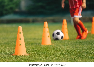 Row Of Football Training Cones. Young Soccer Player Runnning Fast And Kicking Football Ball At Slalom Drill