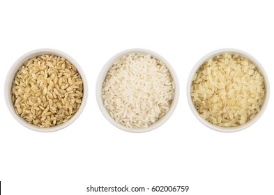 Row glass bowls with parboiled, polished, brown rices isolated on white background. Top view
