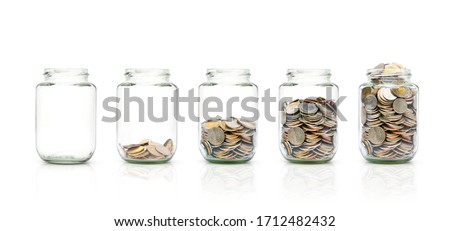 Row of glass jar with coins isolated on white background. Clipping path, Growing savings concept. (Thai baht)