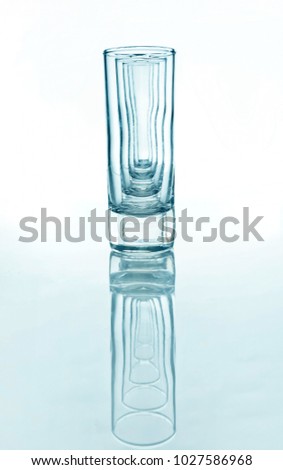 A row of glasses for vodka with reflection