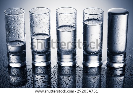 A row of glasses for vodka. studio shot