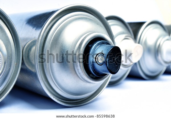 Row of graffiti
aerosol cans - Blue toned