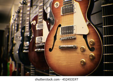 Row Of Guitars On Display For Sale Hanging In A Music Store - Vintage Instagram Filtered 