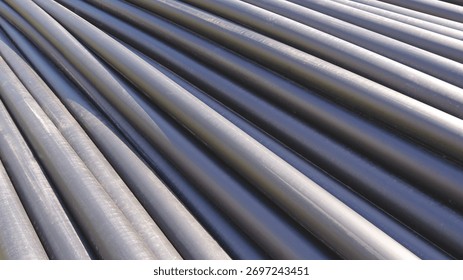 Row of HDPE pipes stack on the ground in construction site for underground water piping installation work