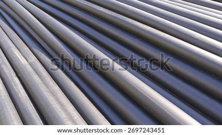 Row of HDPE pipes stack on the ground in construction site for underground water piping installation work