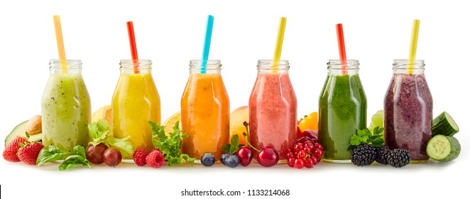Row of healthy fresh fruit and vegetable smoothies with assorted ingredients served in glass bottles with straws isolated on white in a panorama banner